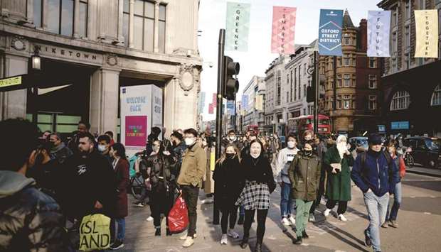 Shoppers and pedestrians cross Oxford Circus in London. The UK economy is firing on all cylinders as it emerges from months of lockdown, with the private sector expanding at the fastest pace in at least 23 years and retail sales surging.