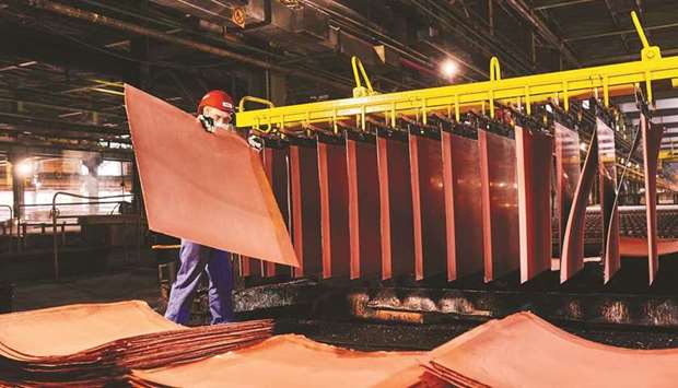 A worker handles newly formed copper cathode sheets in a warehouse at the KGHM Polska Miedz copper smelting plant in Glogow, Poland. Major oil producers, for decades the natural resource industryu2019s top earners, are being eclipsed by once-smaller mining peers who are churning out record profits thanks to red-hot metals markets.