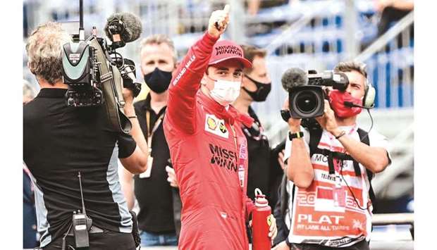 Ferrariu2019s Charles Leclerc reacts in the parc ferme after taking pole position in the qualifying session for the Monaco GP yesterday. (AFP)
