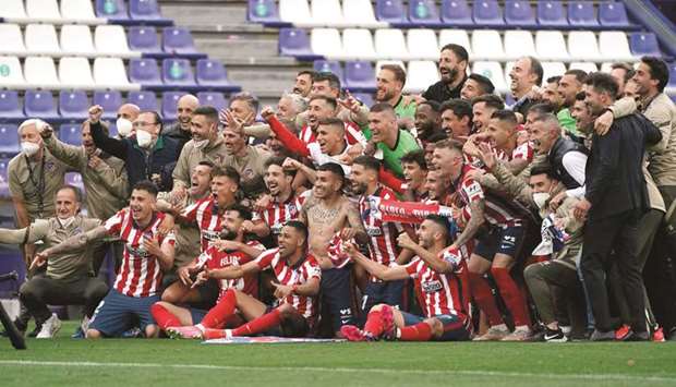 Atletico Madridu00b4s players and staff celebrate after winning the La liga title at the Jose Zorilla stadium in Valladolid, Spain, yesterday. (AFP)
