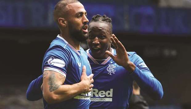 Rangersu2019 Kemar Roofe (left) celebrates scoring their first goal with teammate Joe Aribo during the Premiership match against Celtic at Ibrox Stadium in Glasgow, Scotland, yesterday. (Reuters)