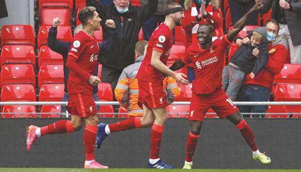 Liverpoolu2019s Sadio Mane (right) celebrates with teammates after scoring a goal against Crystal Palace during their Premier League match at Anfield in Liverpool, England, yesterday. (Below) Liverpool manager Jurgen Klopp. (Reuters)