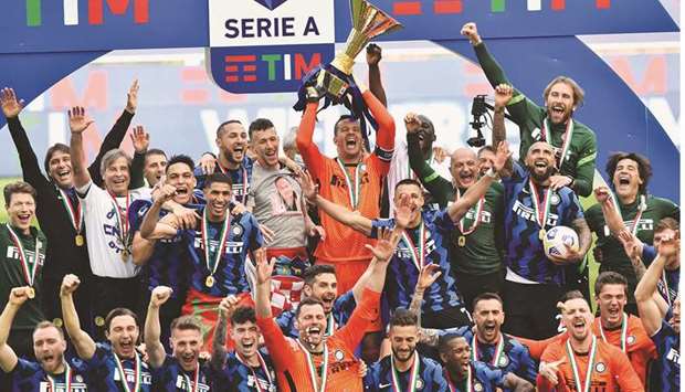 Inter Milan players celebrate with the Serie A trophy after their final match of the league against Udinese at San Siro in Milan, Italy, yesterday. (Reuters)