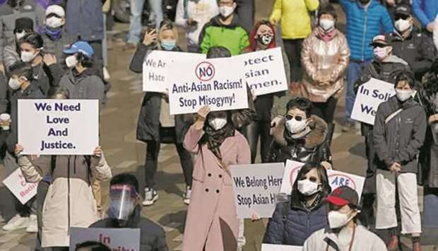 People are seen at a u2018Stop Asian Hateu2019 rally in Vancouver in March.