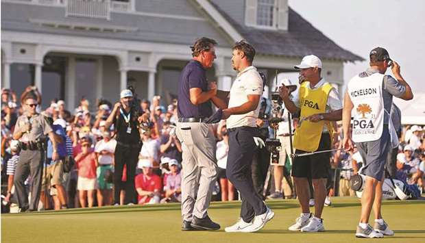 Phil Mickelson of the US is congratulated by compatriot Brooks Koepka after the formeru2019s PGA Championship win on Sunday. (AFP)