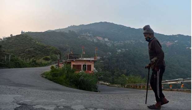An elderly man walks along a deserted hill road during a partial lockdown imposed as preventive measure against the spread of the Covid-19 coronavirus at Kurseong, some 35kms from Siliguri