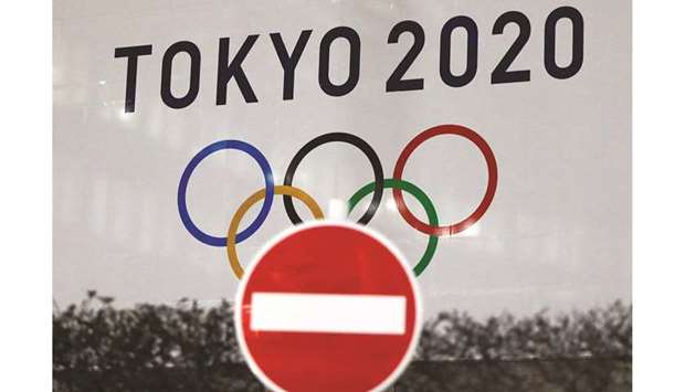 In this January 22, 2021, picture, the logo of Tokyo Olympic Games is seen past a traffic sign at To