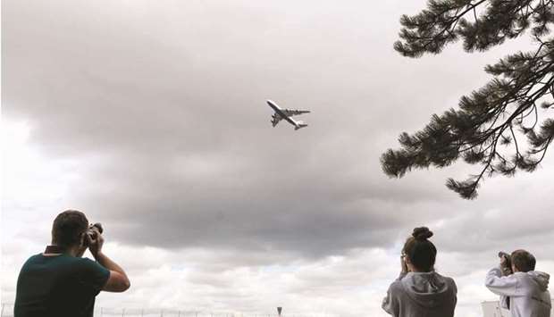 Press photographers take pictures of a departing Boeing 747-400 jumbo jet, operated by British Airways, near Heathrow Airport in London. Tapping into state-provided aid, credit lines, and bond issuances, the airline industry collectively amassed more than $180bn worth of debt in 2020, McKinsey & Company says.