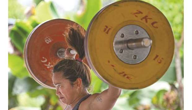 This picture taken on May 21, 2021 shows Olympic weightlifter Hidilyn Diaz of the Philippines during a training session in the Malaysian city of Malacca. Diaz, who took silver at Rio 2016, has been stuck in Malaysia since February last year because of the coronavirus pandemic but has remained determined to realise her dream of becoming the first Olympic gold medal winner from the Philippines.