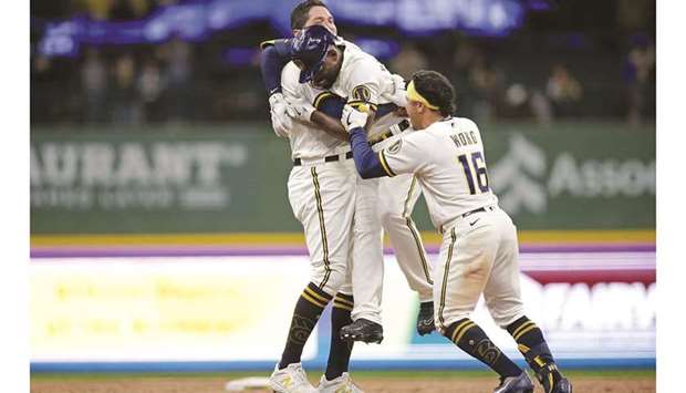 Jackie Bradley Jr. (centre) of the Milwaukee Brewers celebrates with teammates after hitting the game winning run in the tenth inning against the San Diego Padres in Milwaukee, Wisconsin. (AFP)