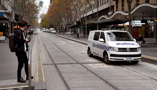 Police patrol Melbourne's usually busy Bourke Street Mall as the city's residents returned to a seven day lockdown to curb the spread of the Covid-19 coronavirus.