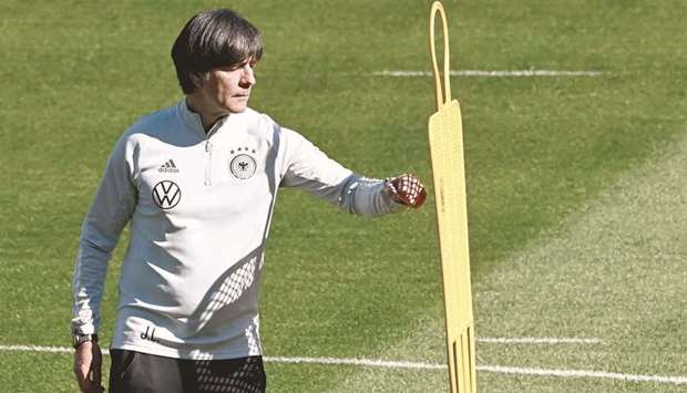 Germanyu2019s coach Joachim Loew checks a dummy during a training session in Seefeld, Austria, where they attend a training camp ahead of the European football championship.