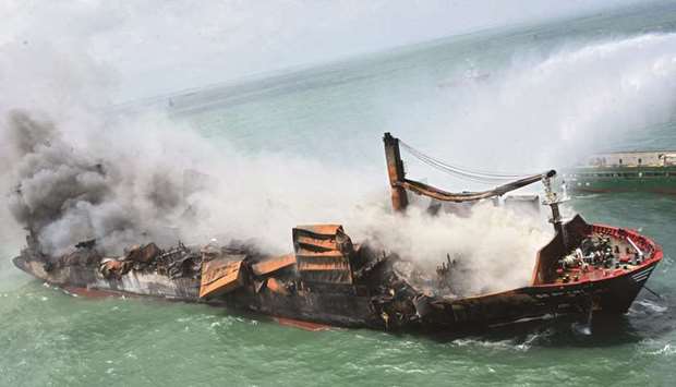 This handout photograph released by the Sri Lanka Air Force yesterday shows smoke billowing from the Singapore-registered container ship MV X-Press Pearl, which has been burning for the tenth consecutive day in the sea off Sri Lankau2019s Colombo Harbour, in Colombo. (AFP)