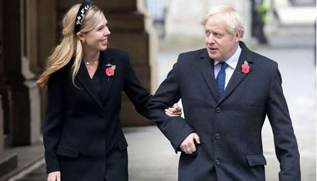Britain's Prime Minister Boris Johnson (R) and his fiancee Carrie Symonds (L) at the Remembrance Sunday ceremony at the Cenotaph on Whitehall in central London. File photo taken on November 8, 2020