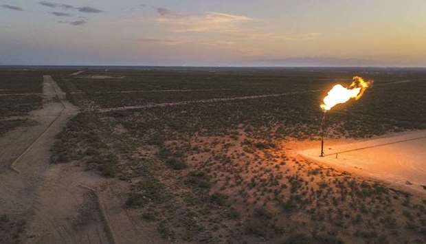 A gas flare burns at dusk in the Permian Basin in Texas, US (file). For the first time in decades, oil companies arenu2019t rushing to increase production to chase rising oil prices as Brent crude approaches $70. Even in the Permian, the prolific shale basin at the centre of the US energy boom, drillers are resisting their traditional boom-and-bust cycle of spending.