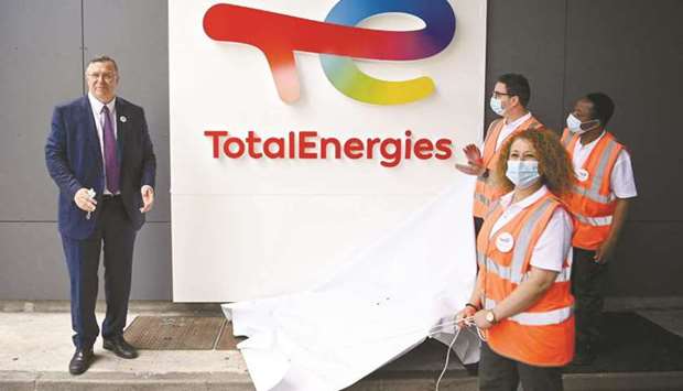Total CEO Patrick Pouyanne (left) and Total employees remove a cover to reveal the new TotalEnergies logo during its unveiling ceremony, at La Defense on the outskirts of Paris on May 28. This new name and new visual identity embody the course TotalEnergies has resolutely charted for itself: that of a broad energy company committed to producing and providing energies that are ever more affordable, reliable and clean.