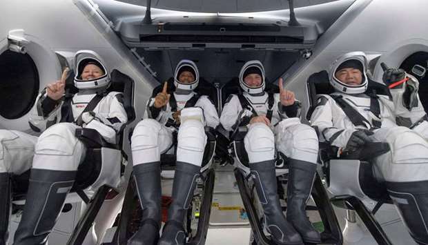 This Nasa handout photo shows Nasa astronauts (from left) Shannon Walker, Victor Glover, Mike Hopkins, and Japan Aerospace Exploration Agency (JAXA) astronaut Soichi Noguchi, inside the SpaceX Crew Dragon Resilience spacecraft onboard the SpaceX GO Navigator recovery ship, shortly after having landed in the Gulf of Mexico off the coast of Panama City, Florida.