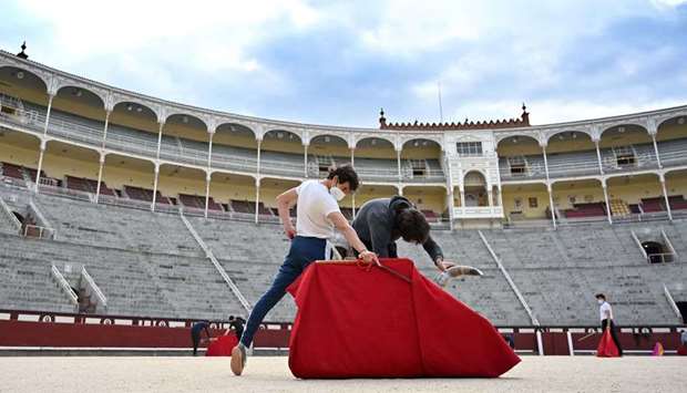 Bullfighting School pupil Alvaro Burdiel, 22, practises at Las Ventas bullring in Madrid. The u201ctoro, toro!u201d resonate even louder in the void of the Las Ventas arena in Madrid, the most prestigious in the world, where Alvaro and Guillermo, two young apprentice bullfighters whose career was brought to a halt by the pandemic, train. (AFP)