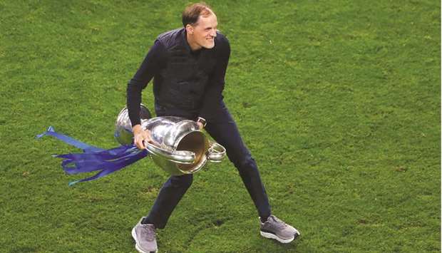 Chelseau2019s German coach Thomas Tuchel celebrates with the trophy after winning the UEFA Champions League final football match at the Dragao stadium in Porto on Saturday.