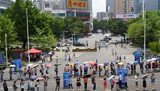 People line up to receive the coronavirus disease (COVID-19) vaccine outside a vaccination site in Guangzhou, Guangdong province, China