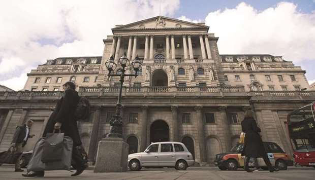 Pedestrians pass the Bank of England in London. The UKu2019s economic rebound from the pandemic is fuelling speculation that BoE policy makers this week will start discussing how and when they can ease their foot off the stimulus pedal.