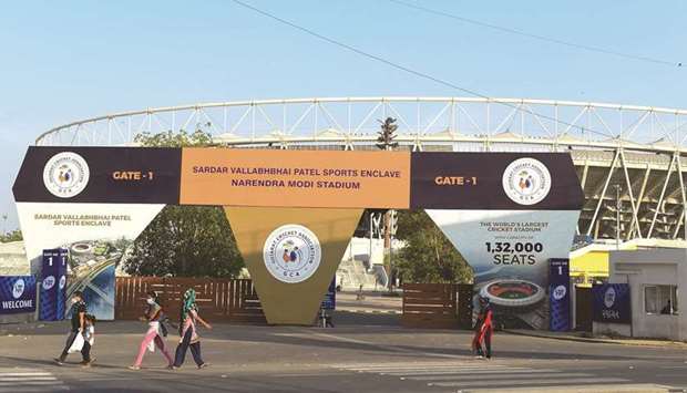 People make their way past the main entrance of the Narendra Modi Stadium, a venue where cricket matches were taking place during the 2021 Indian Premier League (IPL).