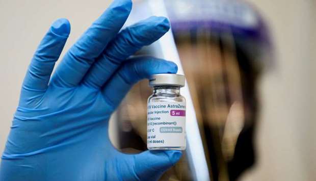 A medical worker holds a bottle of AstraZeneca's Covid-19 vaccine at a vaccination centre