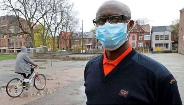 Apollinaire Nduwimana, a Burundian teacher and asylum-seeker who is awaiting a refugee application, poses outside a school near his lodging in Toronto, Ontario, Canada April 29, 2021. (REUTERS)