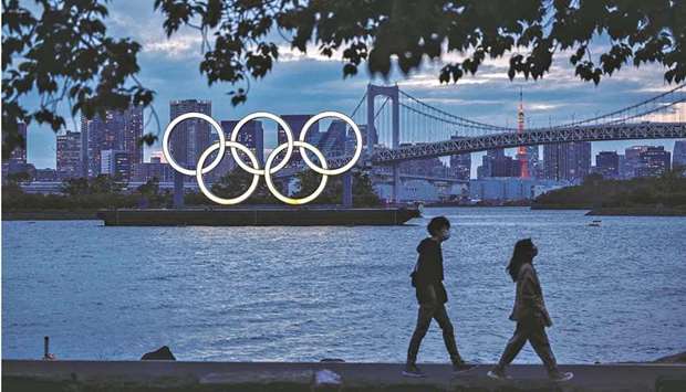 The Olympic rings are lit up at dusk at the Odaiba waterfront in Tokyo, Japan, last week. (AFP)