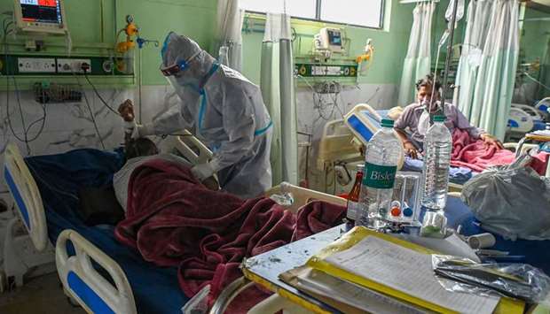 A health worker wearing a personal protective equipment (PPE) suit attends to a Covid-19 coronavirus patient inside the Intensive Care Unit (ICU) of the Teerthanker Mahaveer University (TMU) hospital in Moradabad