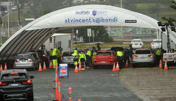 Medical officers conduct a mass Covid-19 testing at a parking lot on Bondi Beach in Sydney as administration implementing new restrictions after new cases of community transmission.