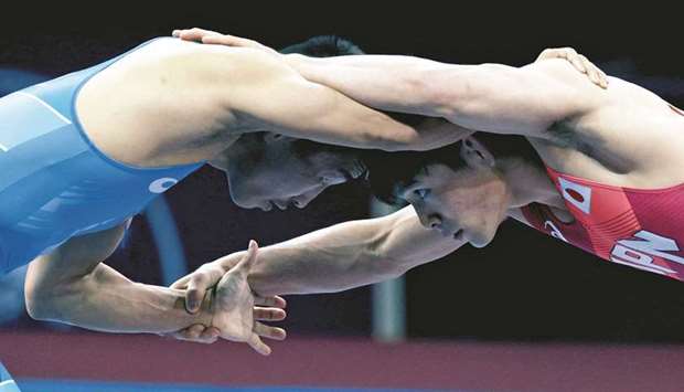 Japanu2019s Yuki Takahashi in action against Mongoliau2019s Erdenebat Bekhbayar during their 57kg bout in an Olympics qualifying wrestling tournament in Sofia, Bulgaria, yesterday.
