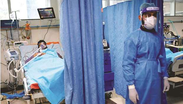 A man suffering from coronavirus disease (Covid-19) receives treatment as a Syringe Infusion Pump, donated by France is seen next to his bed, inside the emergency room of Safdarjung Hospital in New Delhi, yesterday.