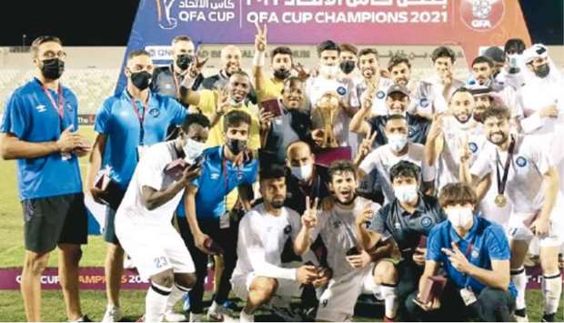 Al Sailiya players and support staff celebrate after winning the QFA Cup.