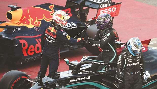 Mercedesu2019 British driver Lewis Hamilton (C) is congratulated by Red Bullu2019s Dutch driver Max Verstappen (L) at the Circuit de Catalunya in Montmelo, on the outskirts of Barcelona, yesterday.