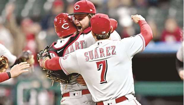 Cincinnati Reds starting pitcher Wade Miley (centre) and catcher Tucker Barnhart and third baseman Eugenio Suarez (right) celebrate after Miley threw a no-hitter against the Cleveland Indians in Cleveland. (USA TODAY Sports)
