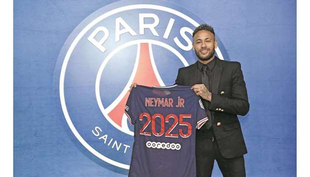 Neymar poses with a Paris Saint-Germain jersey after signing a new contract yesterday.