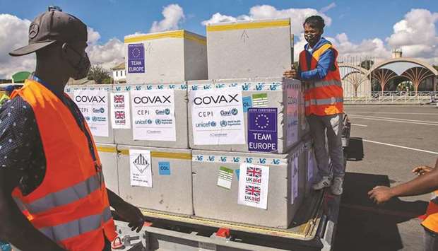 Workers handle boxes of Oxford/AstraZeneca Covid-19 vaccines,after these arrived by plane at the Ivato International Airport in Antananarivo yesterday.