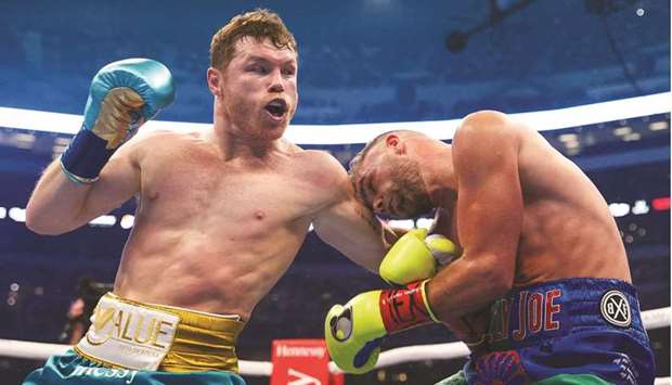 In this handout photo provided by Matchroom Boxing, Mexican boxer Saul u201cCanelou201d Alvarez (L) hits British boxer Billy Joe Saunders during their super middleweight title fight at the AT&T Stadium in Arlington, Texas.
