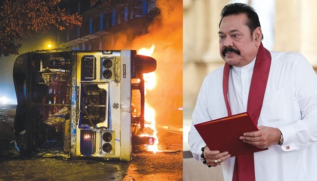 A bus burns close to the official residence of Sri Lankau2019s outgoing prime minister Mahinda Rajapaksa (right), in Colombo yesterday. Dozens of buses used by Rajapaksa loyalists to travel to Colombo earlier in the day were torched or damaged across the country. (AFP, Reuters)