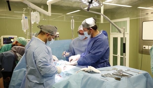 Dr Raed al-Arini, a thoracic surgery consultant hired by Qatar Red Crescent Society in Gaza, performs a pneumonectomy for a 15-year-old child in the second week of May this year.