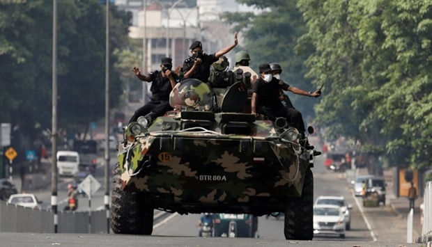 Army members travel on an armoured car on the main road after the curfew was extended for another extra day following a clash between Anti-government demonstrators and Sri Lanka's ruling party supporters, amid the country's economic crisis, in Colombo, Sri Lanka. REUTERS
