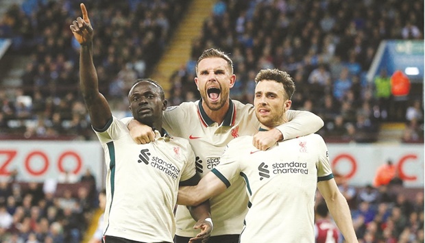 Liverpoolu2019s Sadio Mane (left) celebrates with Jordan Henderson (centre) and Diogo Jota after scoring against Aston Villa during the Premier League match at Villa Park in Birmingham, central England, on Wednesday night. (AFP)