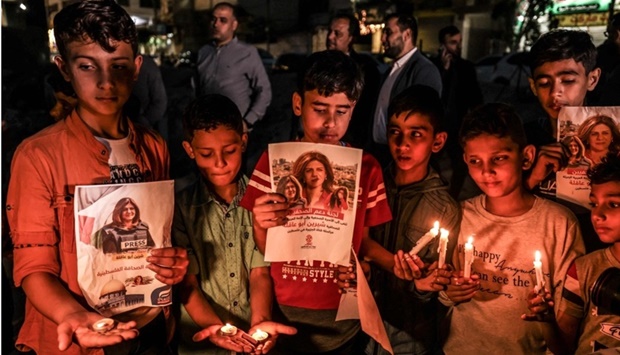 Children take part in a candlelight vigil to condemn the killing of veteran Al-Jazeera journalist Shireen Abu Akleh, in Gaza City. AFP