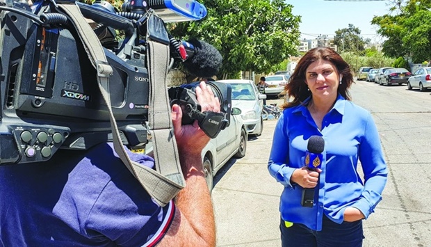 This handout file picture obtained from a former colleague of Al Jazeera's late veteran TV journalist Shireen Abu Akleh, shows her reporting for the Qatar-based news channel from Jerusalem on May 22, 2021.