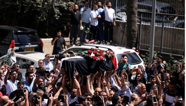 Family and friends of Al Jazeera reporter Shireen Abu Akleh, who was killed during an Israeli raid in Jenin in the occupied West Bank, carry her body as she arrives in Jerusalem, May 12. REUTERS