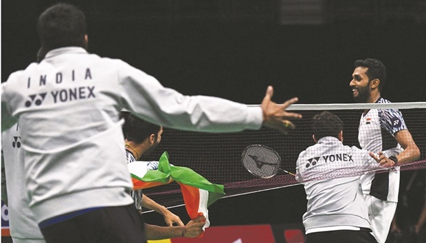 Members of Indiau2019s badminton team celebrate after Indiau2019s H S Prannoy (right) won against Denmarku2019s Rasmus Gemke during the semi-finals of the Thomas and Uber Cup in Bangkok yesterday. (AFP)