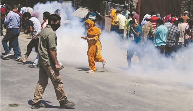 Police fire tear gas to disperse demonstrators marching towards the governoru2019s house to protest against the killing of a government employee belonging to the Kashmiri Pandit community on the outskirts of Srinagar yesterday.