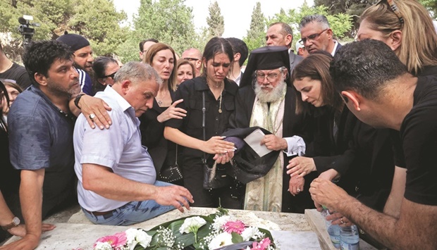 Mourners gather during the burial of slain veteran Al Jazeera journalist Shireen Abu Akleh at the cemetery outside Jerusalemu2019s Old City, yesterday.