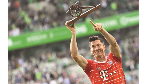 Bayern Munichu2019s Polish forward Robert Lewandowski poses with Bundesliga top scorer trophy after the final league game against VfL Wolfsburg in Wolfsburg, northern Germany, yesterday. (Reuters)